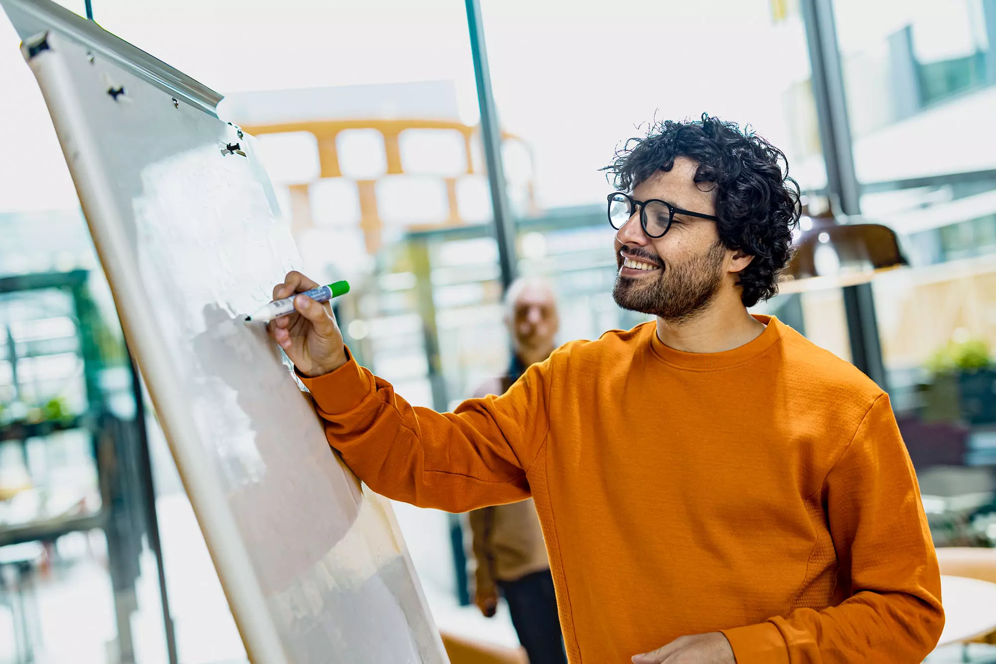 Picture of a person writing on the flip chart Person drawing on the flip chart