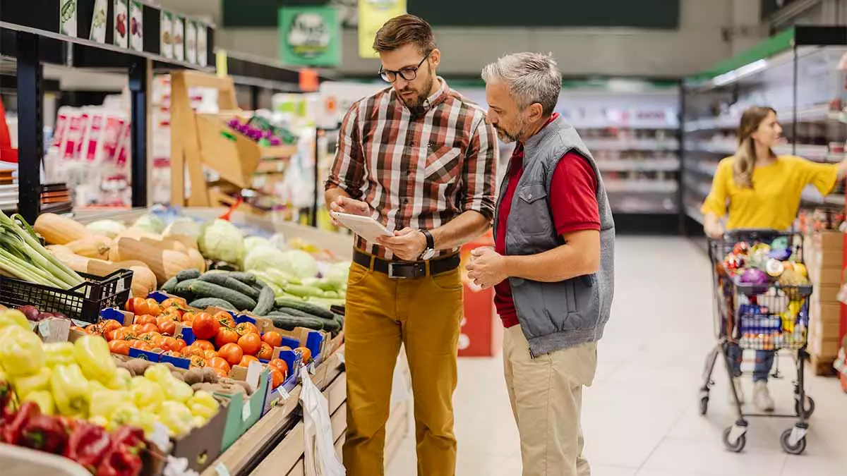 Two men working at the greengrocer