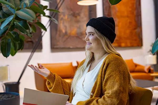 A woman is sitting and smiling